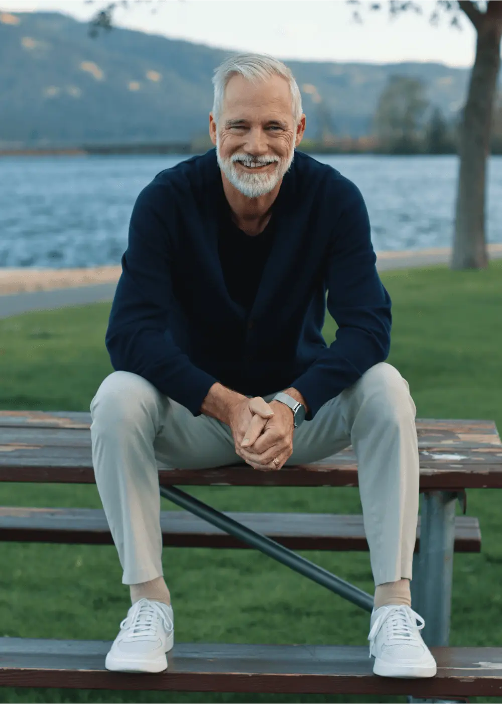 Headshot of Joe Woodruff Smiling Sitting on Bench in Park